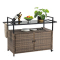 Outdoor light brown large portable wicker cart with wheels, black glass tabletop, suitable for terrace barbecue, backyard, parties, bar service vehicles